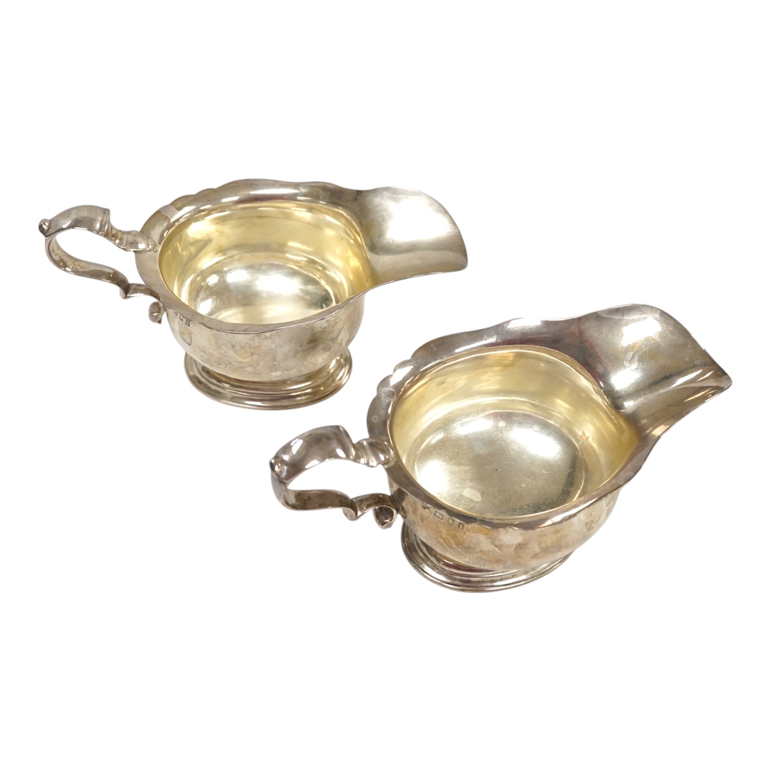 A pair of George V silver sauceboats, by Goldsmiths & Silversmiths Co Ltd, London, 1924, length 17.1cm, 14.7oz. Condition - fair to good